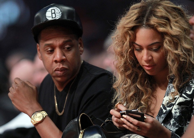 HOUSTON, TX - FEBRUARY 17: Jay-Z looks over at wife Beyonce during the 2013 NBA All-Star game at the Toyota Center on February 17, 2013 in Houston, Texas. NOTE TO USER: User expressly acknowledges and agrees that, by downloading and or using this photograph, User is consenting to the terms and conditions of the Getty Images License Agreement. (Photo by Ronald Martinez/Getty Images)